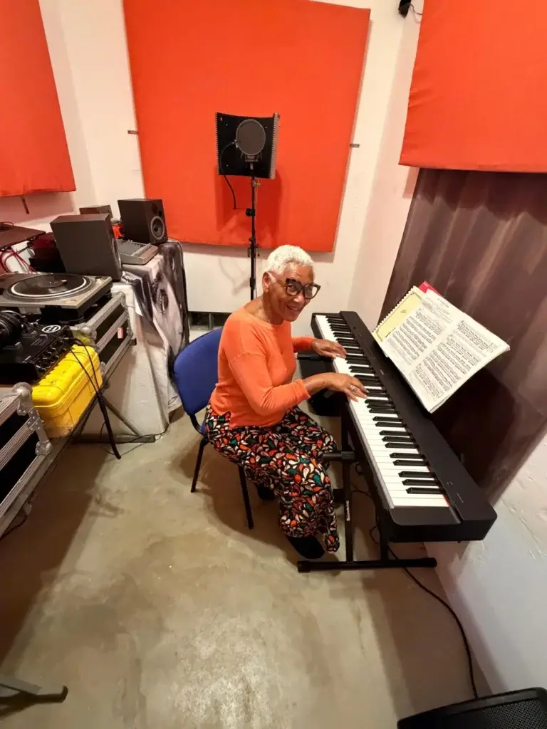 Musician at the keyboard inside Bliss Beats recording studio