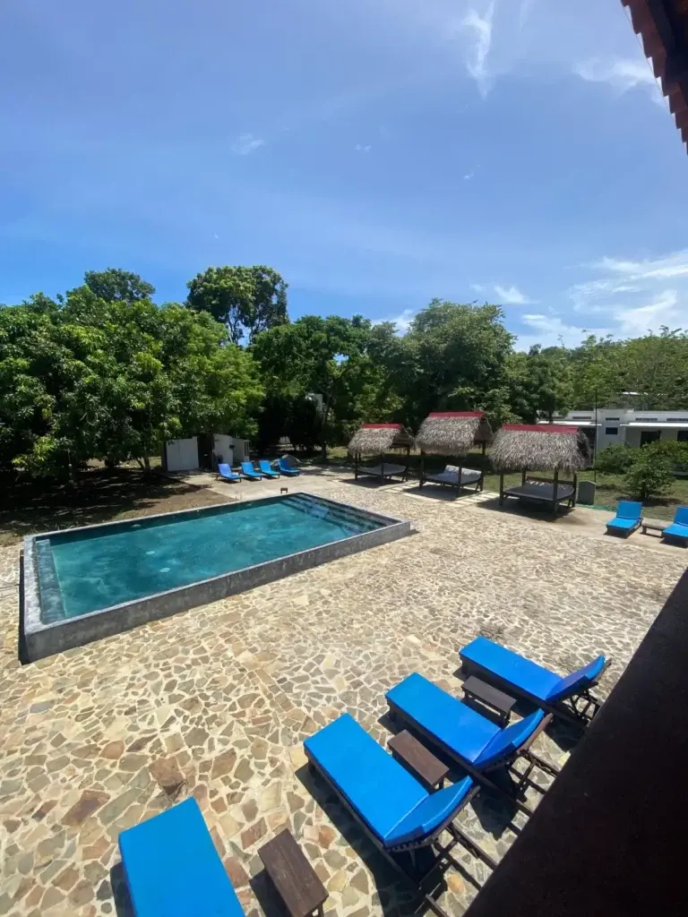 Saltwater pool with stone deck, loungers and cabanas