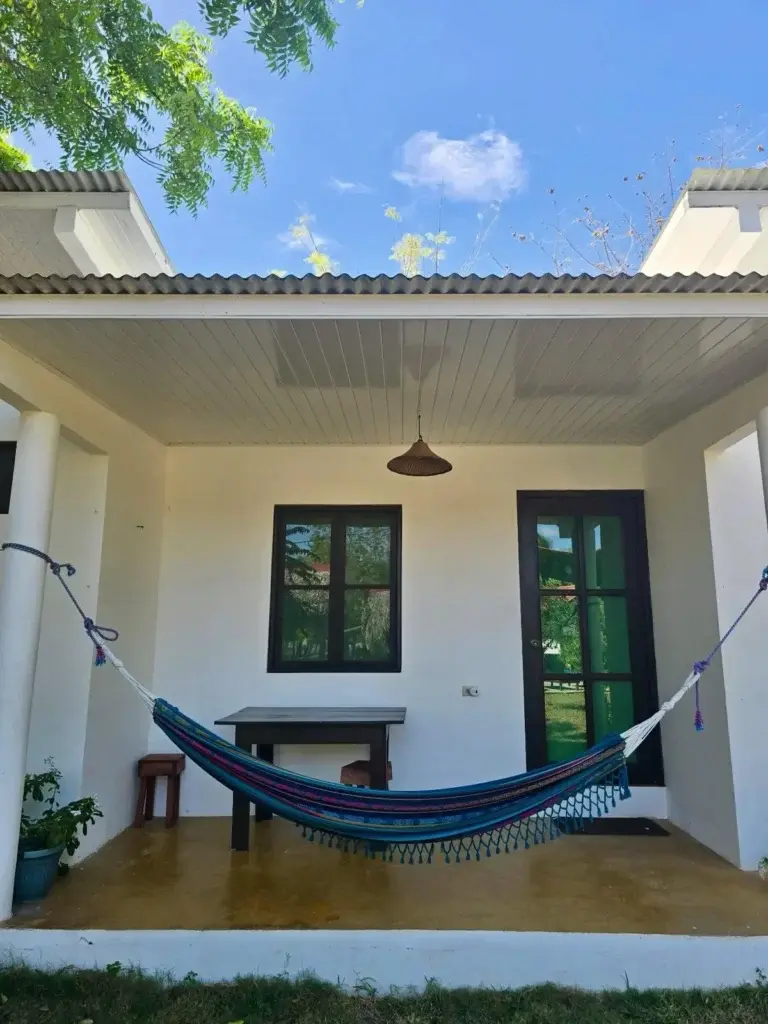 Garden room patio with a hammock and table