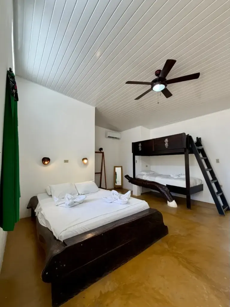 Garden room with a double bed, bunk bed and ceiling fan