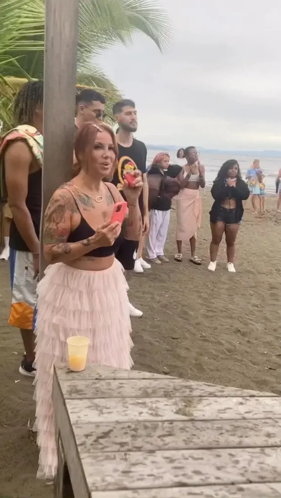 Performer with guests at a beachfront music festival at Bliss Beach