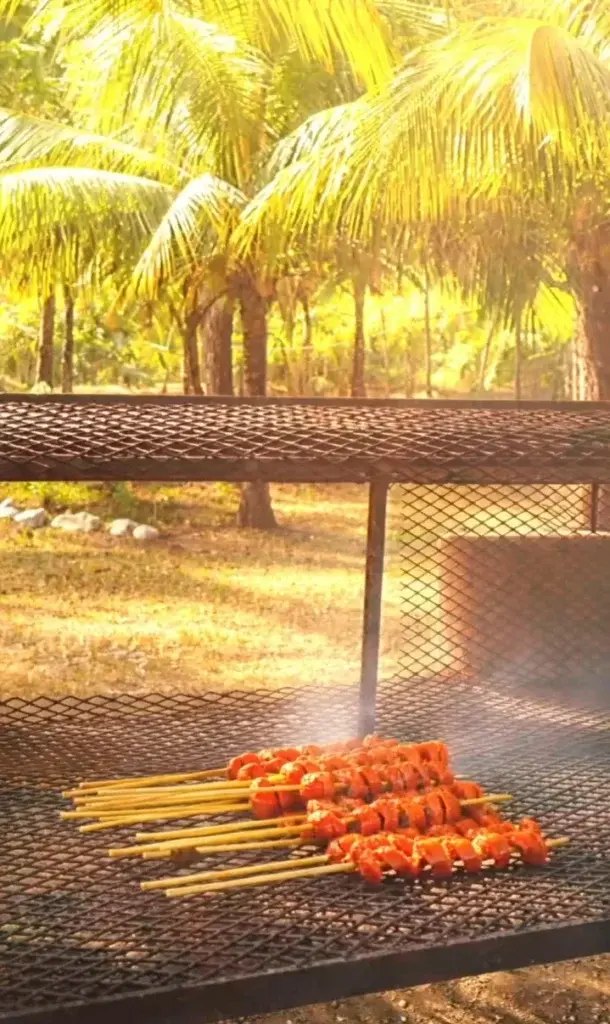 Skewers sizzling on the grill at the Carnival BBQ