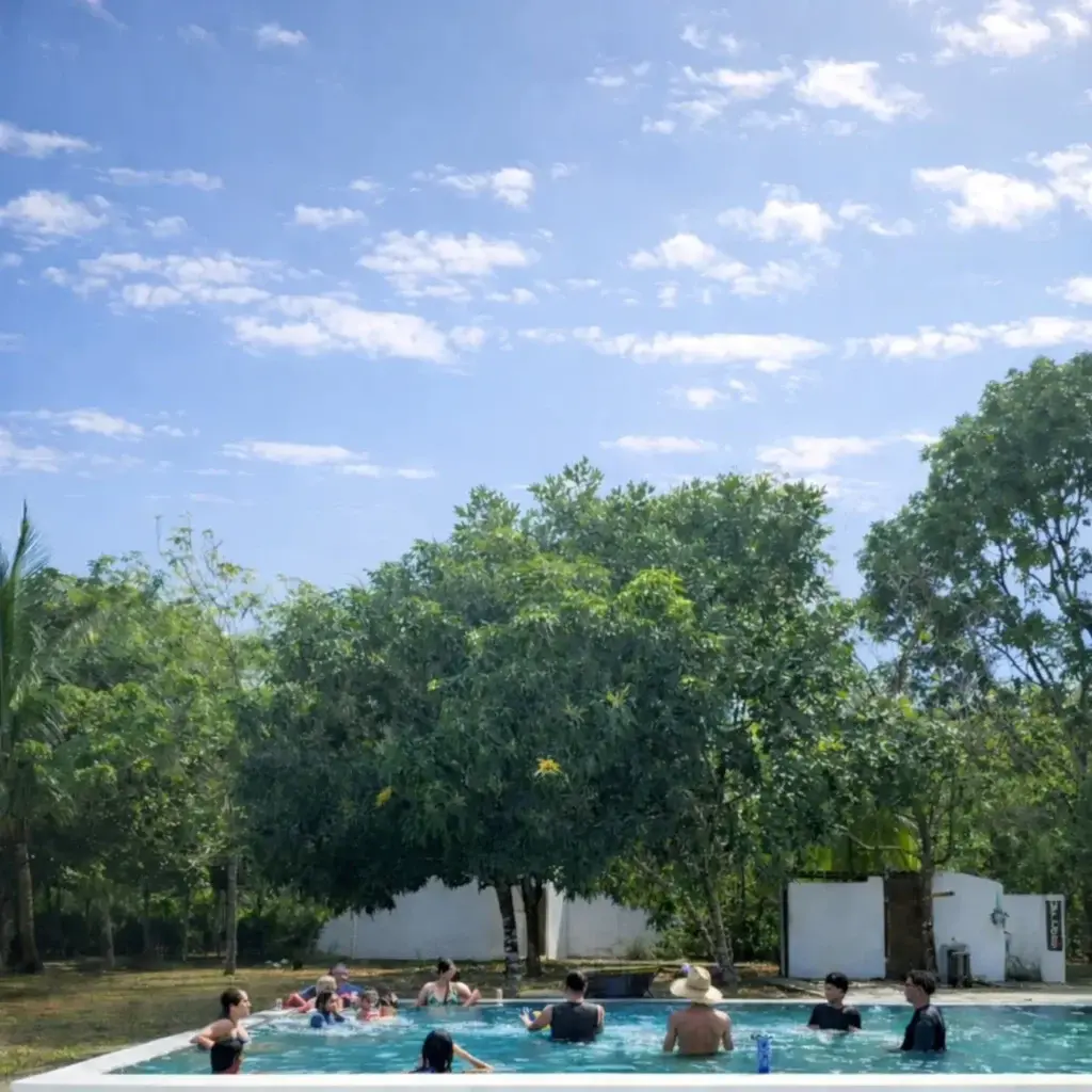 Guests enjoying a sunny pool day at Bliss Beach