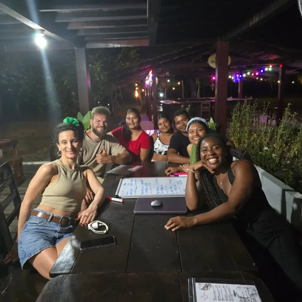 Friends gathered around a table at a community night