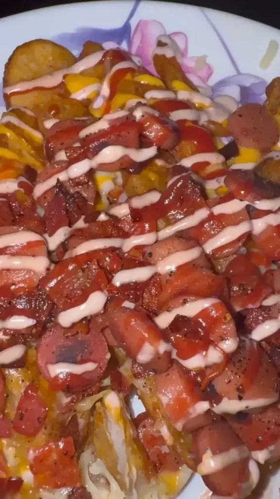 Tostones topped with sausage and sauce