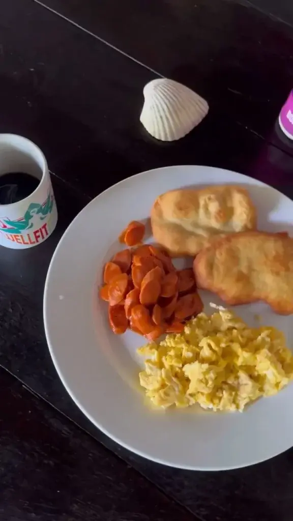Breakfast plate with eggs, sausage and fried dough