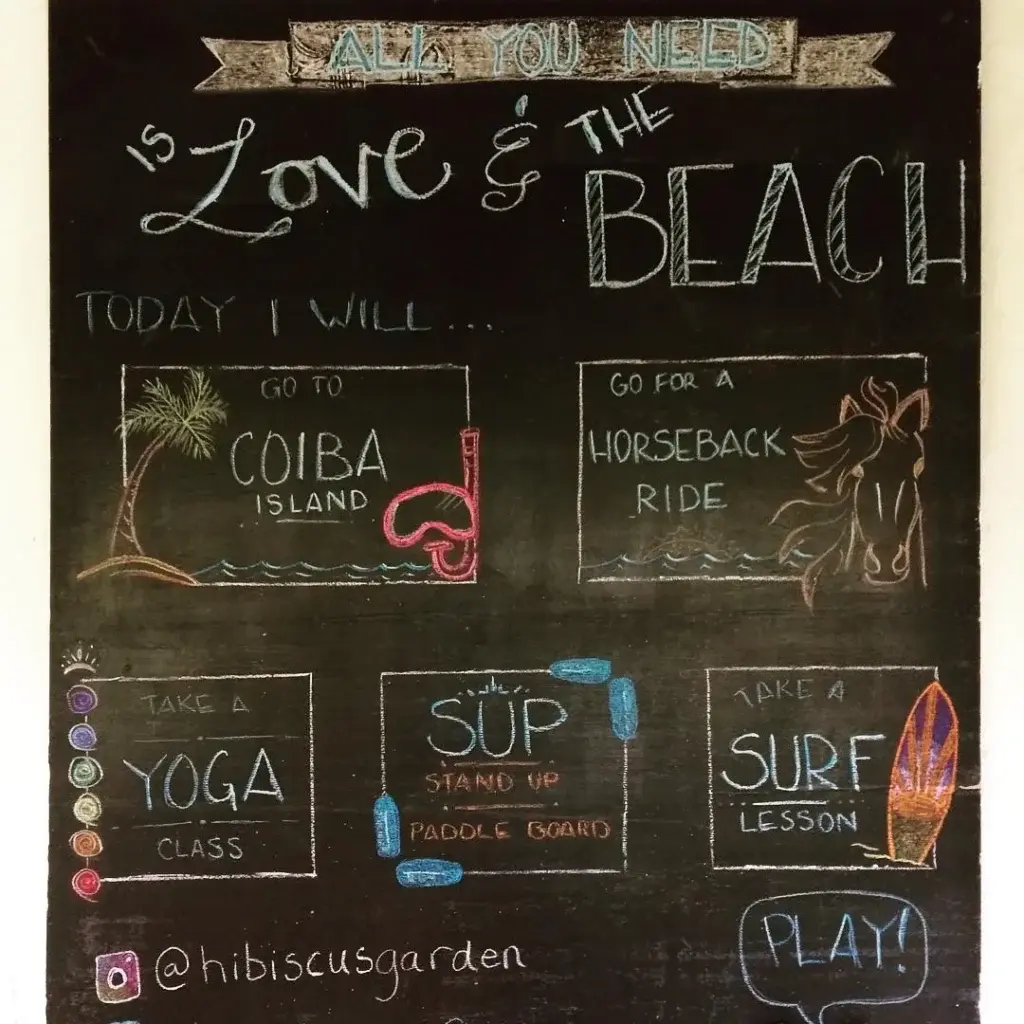 Chalkboard of daily activities drawn by a Bliss Beach volunteer