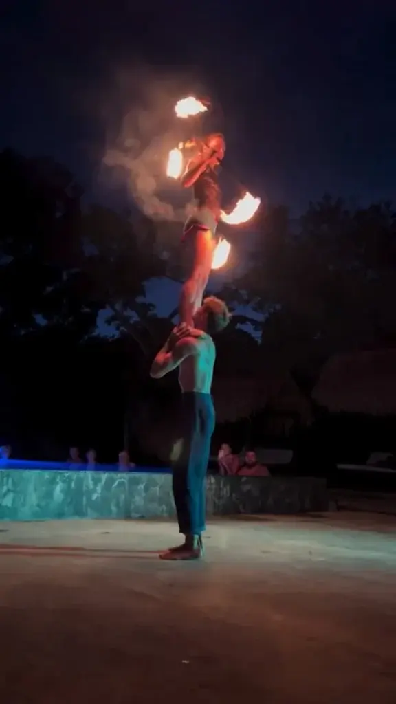 Partner lift with flaming props by the pool